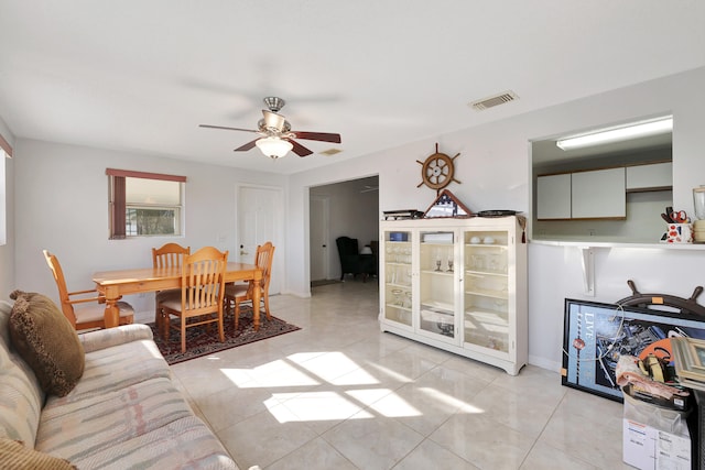 tiled living room with ceiling fan