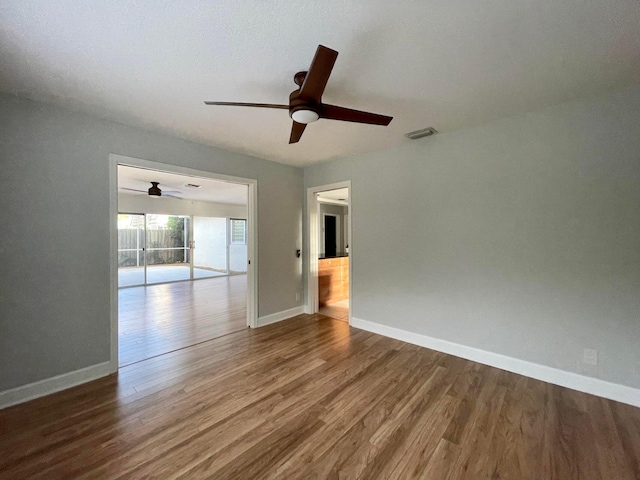 spare room featuring wood-type flooring and ceiling fan