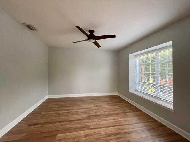 spare room featuring wood-type flooring and ceiling fan