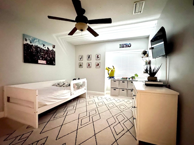 bedroom featuring baseboards, a ceiling fan, and visible vents