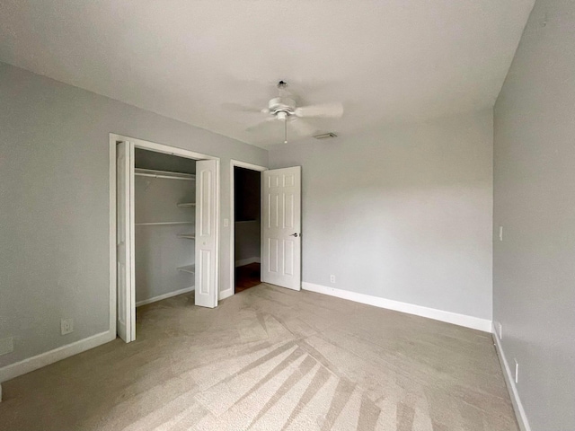 unfurnished bedroom with light carpet, ceiling fan, and a closet