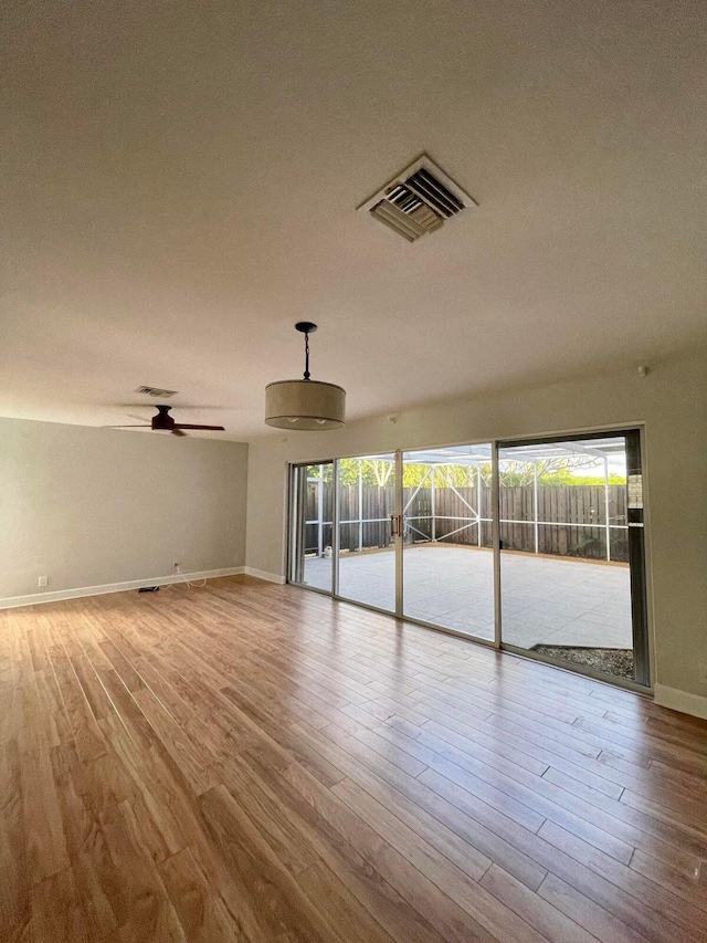 spare room featuring light hardwood / wood-style flooring and ceiling fan