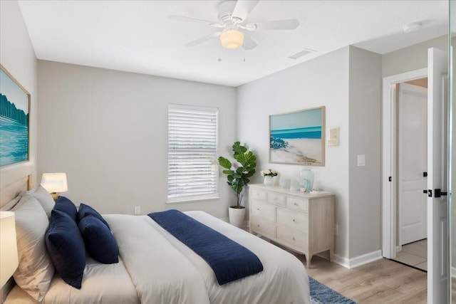 bedroom with light hardwood / wood-style flooring and ceiling fan