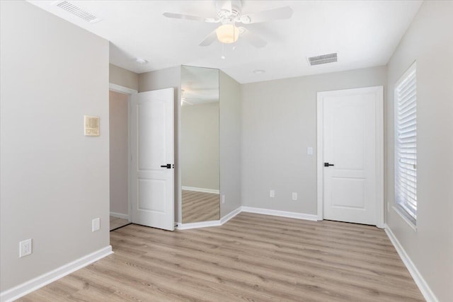 unfurnished bedroom with light wood-type flooring and ceiling fan