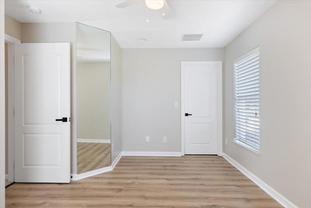 unfurnished bedroom featuring light hardwood / wood-style flooring and ceiling fan