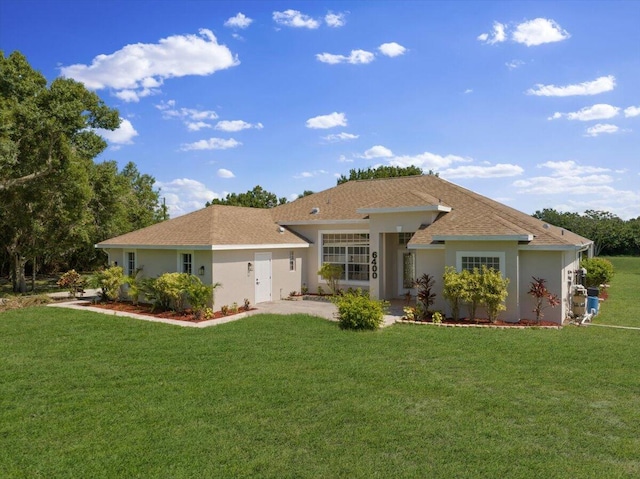 rear view of property with a garage and a yard