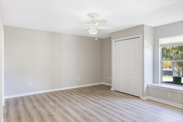 unfurnished bedroom with ceiling fan, light hardwood / wood-style flooring, and a closet