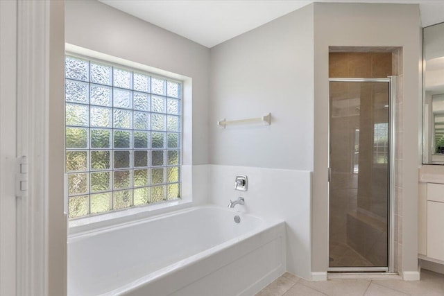 bathroom featuring shower with separate bathtub and tile patterned flooring