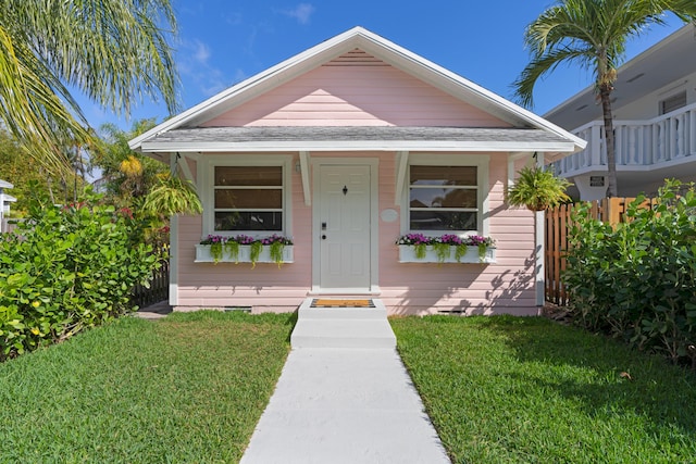 bungalow-style house featuring a front yard