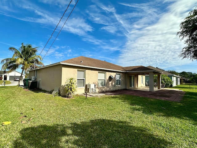 back of property featuring a lawn and a patio area