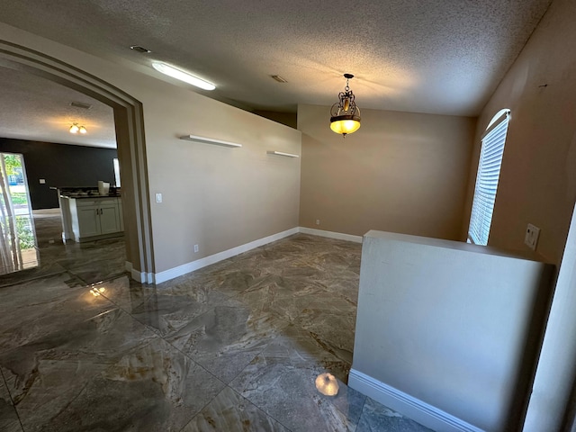 interior space featuring a textured ceiling