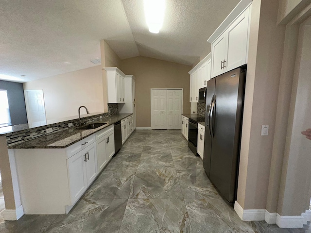 kitchen with black appliances, lofted ceiling, white cabinetry, and sink