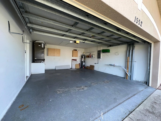 garage with electric water heater, heating unit, a garage door opener, and electric panel