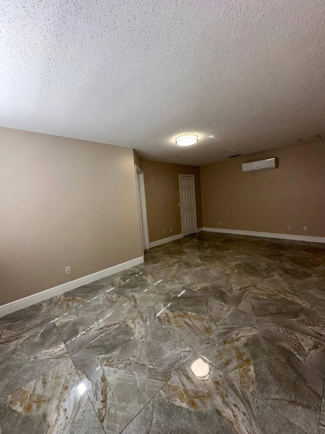 spare room with a textured ceiling and a wall mounted AC