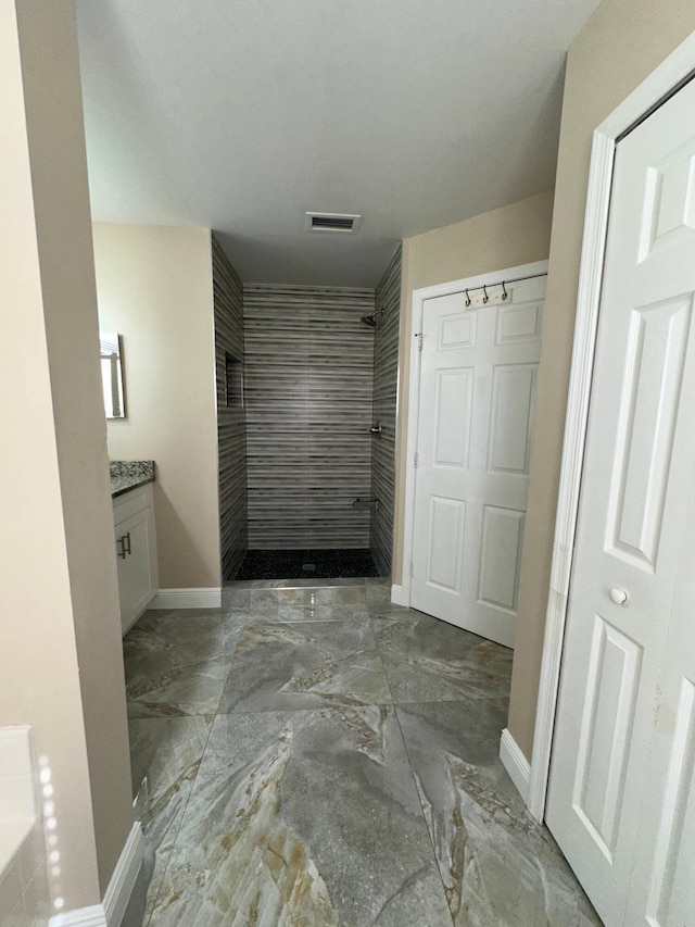 bathroom with walk in shower and vanity