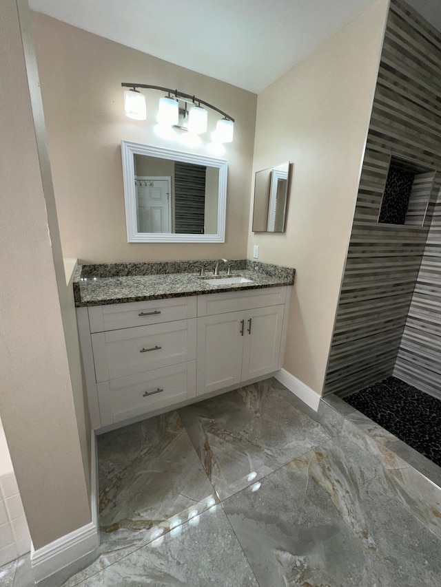 bathroom featuring walk in shower and vanity