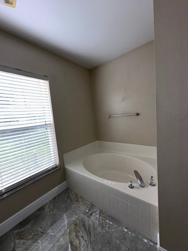 bathroom with tiled bath