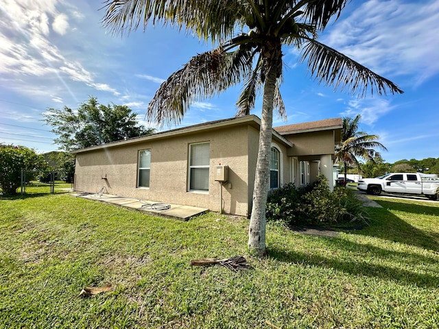 view of side of home featuring a lawn