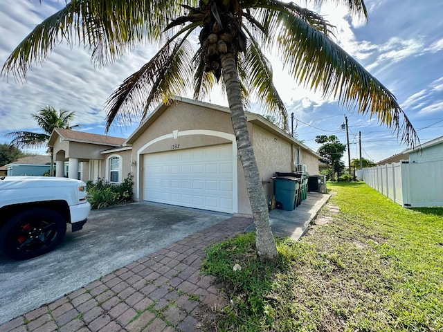 view of property exterior with a lawn and a garage