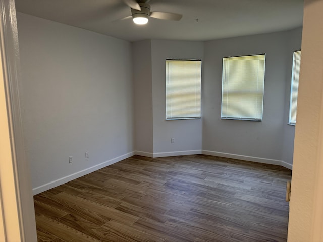 empty room with hardwood / wood-style floors and ceiling fan