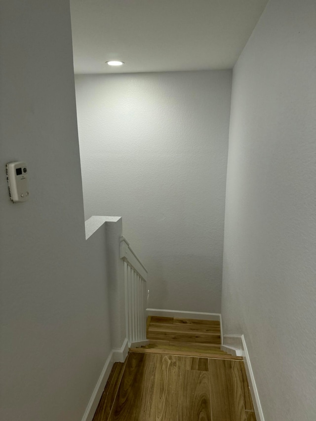 stairway with hardwood / wood-style flooring