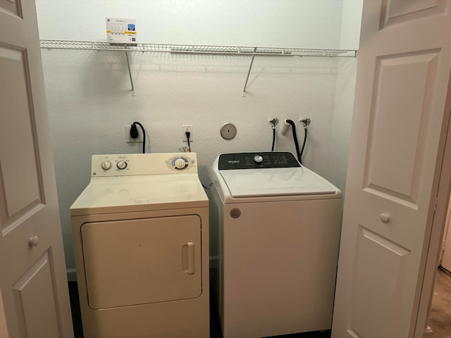 laundry room featuring washing machine and clothes dryer