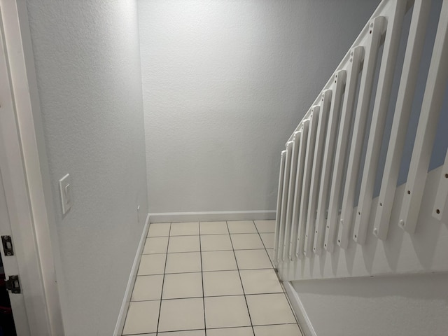 stairway featuring tile patterned floors