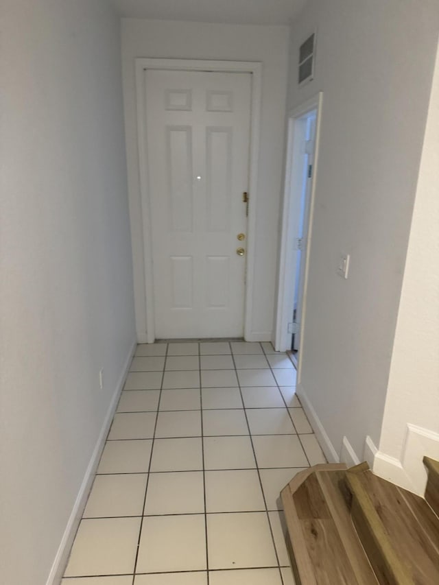 hall with light tile patterned floors