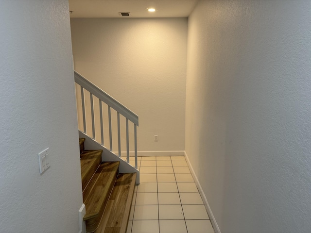 stairs with tile patterned floors