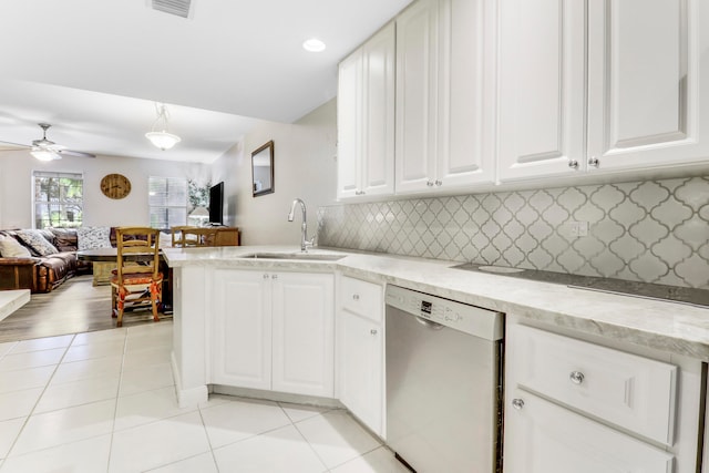 kitchen featuring decorative backsplash, stainless steel dishwasher, white cabinetry, and sink