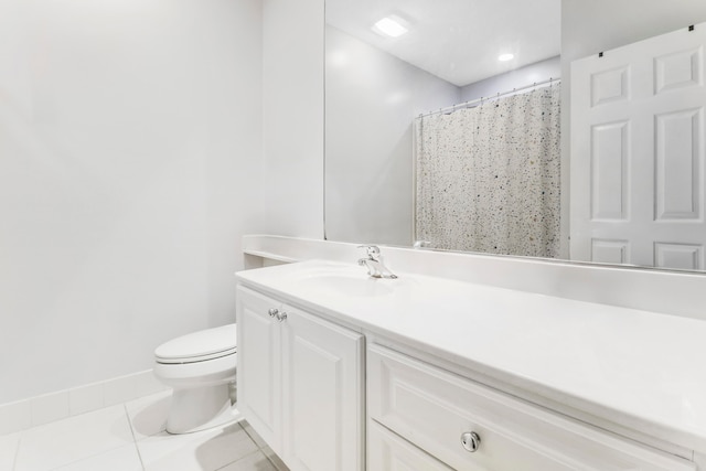 bathroom with vanity, toilet, and tile patterned floors