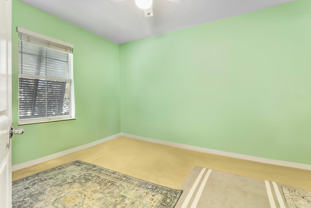 empty room with ceiling fan and carpet flooring