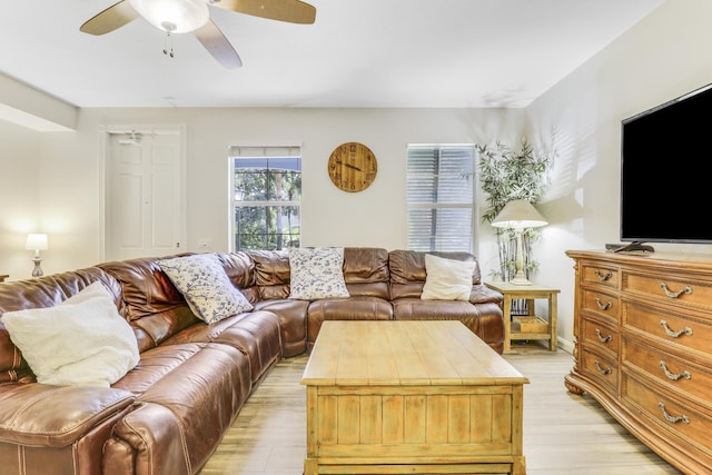 living area with light wood-style flooring and ceiling fan