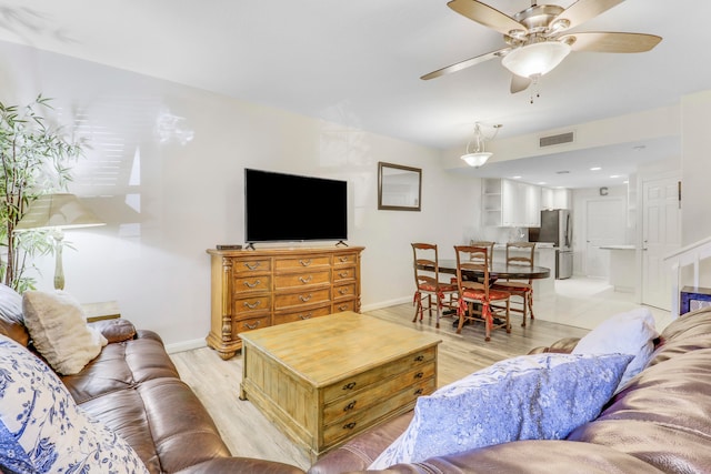 living room featuring light hardwood / wood-style flooring and ceiling fan