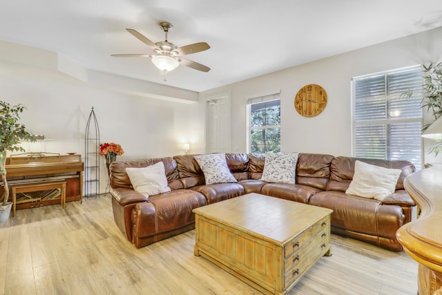 living room featuring ceiling fan and light hardwood / wood-style flooring