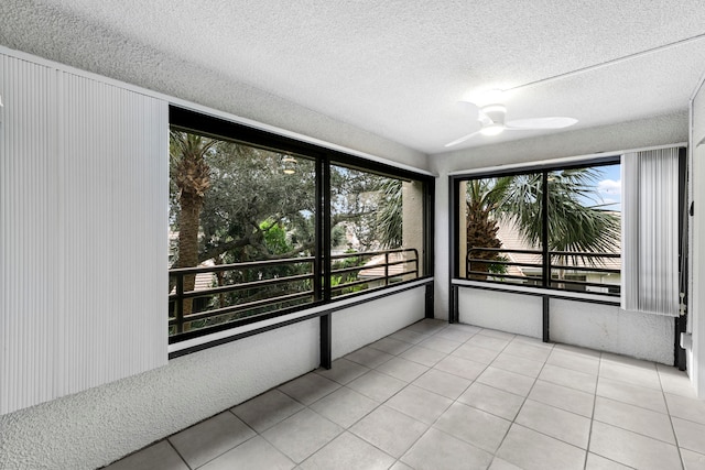 unfurnished sunroom featuring ceiling fan