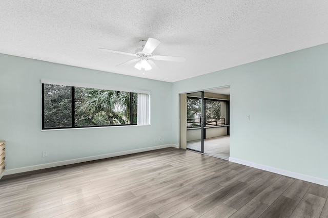 unfurnished room featuring a textured ceiling, ceiling fan, and light hardwood / wood-style flooring