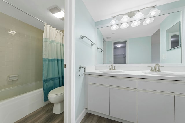 full bathroom with toilet, shower / tub combo with curtain, vanity, and hardwood / wood-style floors