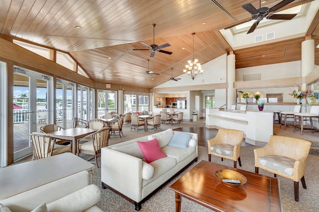 carpeted living room featuring wooden ceiling, a chandelier, a skylight, and high vaulted ceiling