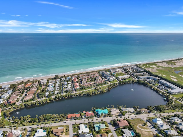 drone / aerial view with a beach view and a water view