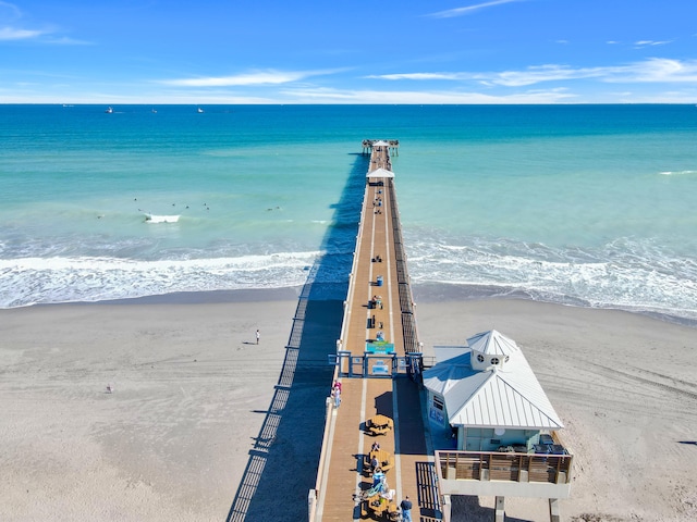 drone / aerial view featuring a beach view and a water view