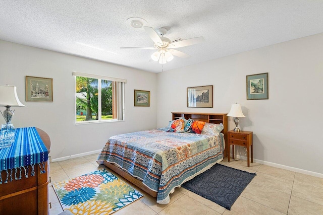 tiled bedroom featuring a textured ceiling and ceiling fan