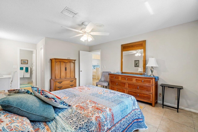 bedroom featuring a textured ceiling, light tile patterned floors, and ceiling fan