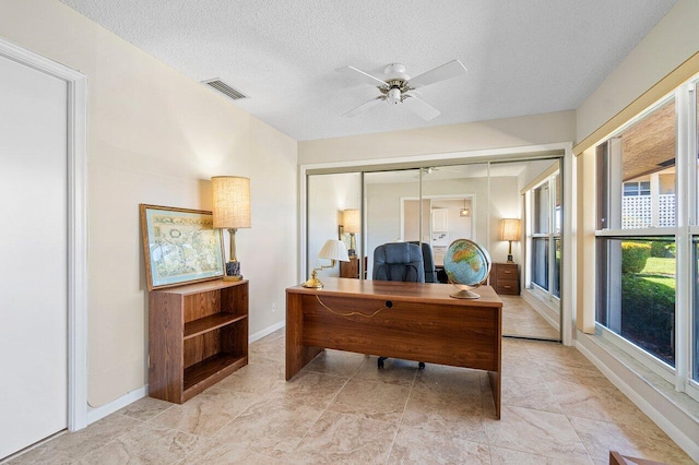 office area featuring ceiling fan and a textured ceiling