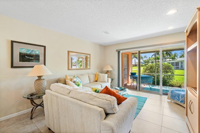 living room with a textured ceiling and light tile patterned floors