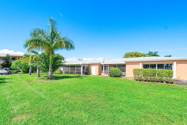 ranch-style home with a front lawn