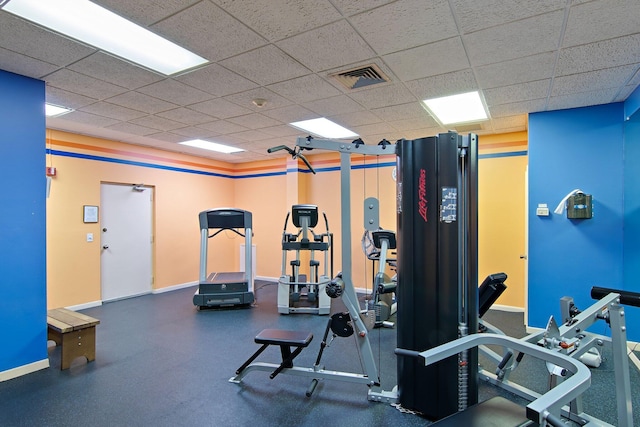 workout area with a paneled ceiling