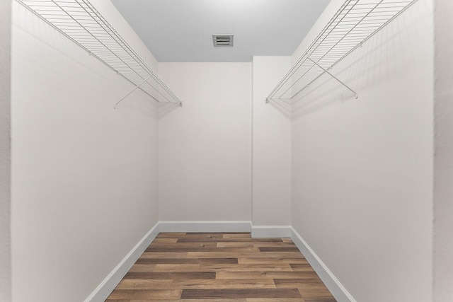 spacious closet with hardwood / wood-style floors