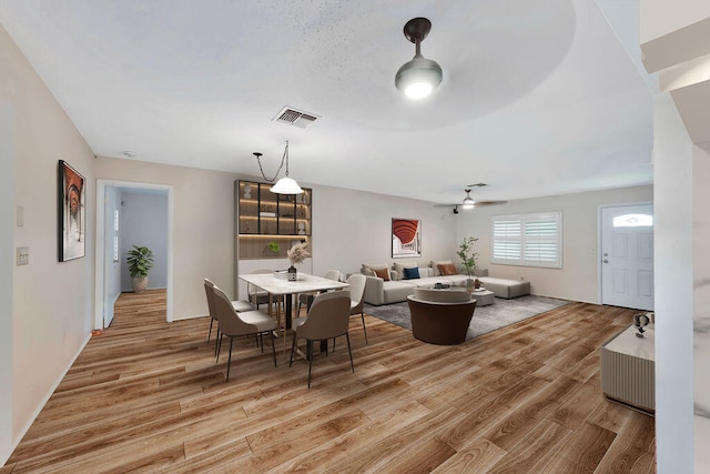 dining area featuring light hardwood / wood-style floors and ceiling fan