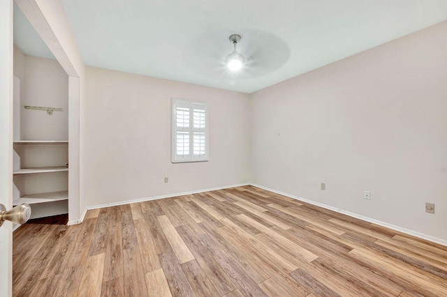 unfurnished room with light wood-type flooring and ceiling fan